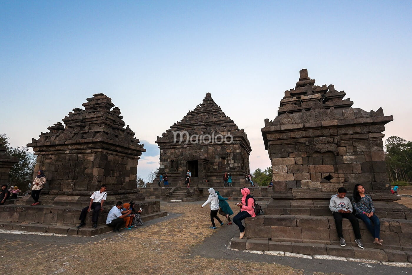 Visitors relaxing and exploring the ancient stone temples of Ijo Temple.