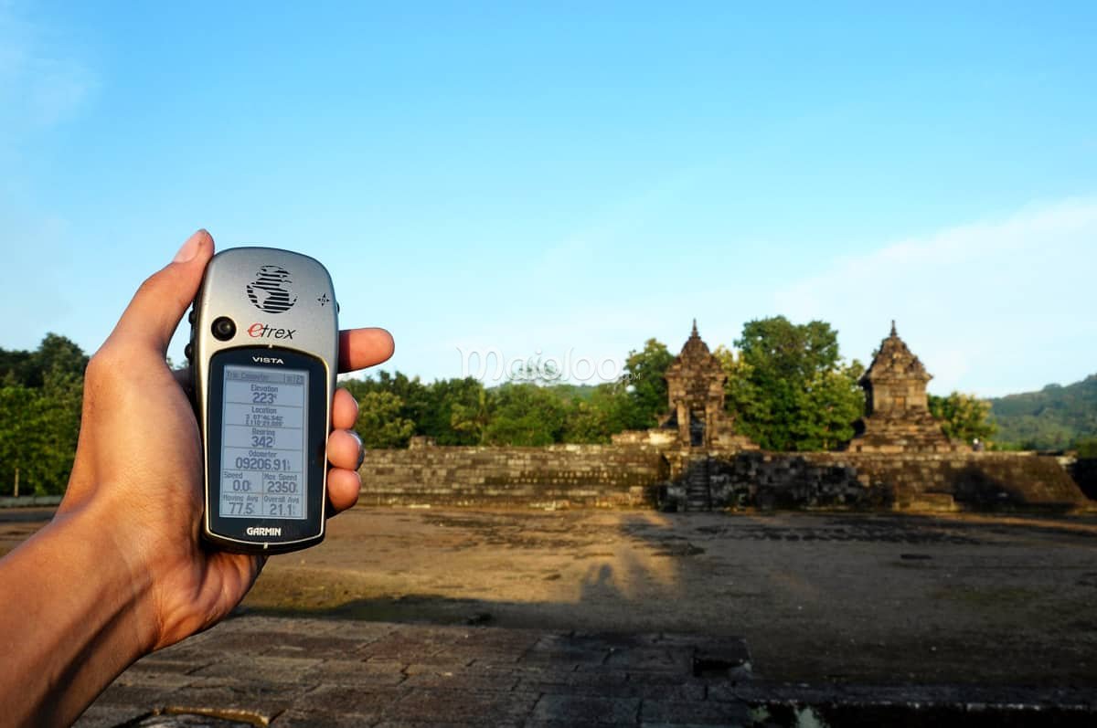 Hand holding a GPS device showing the location of Barong Temple.