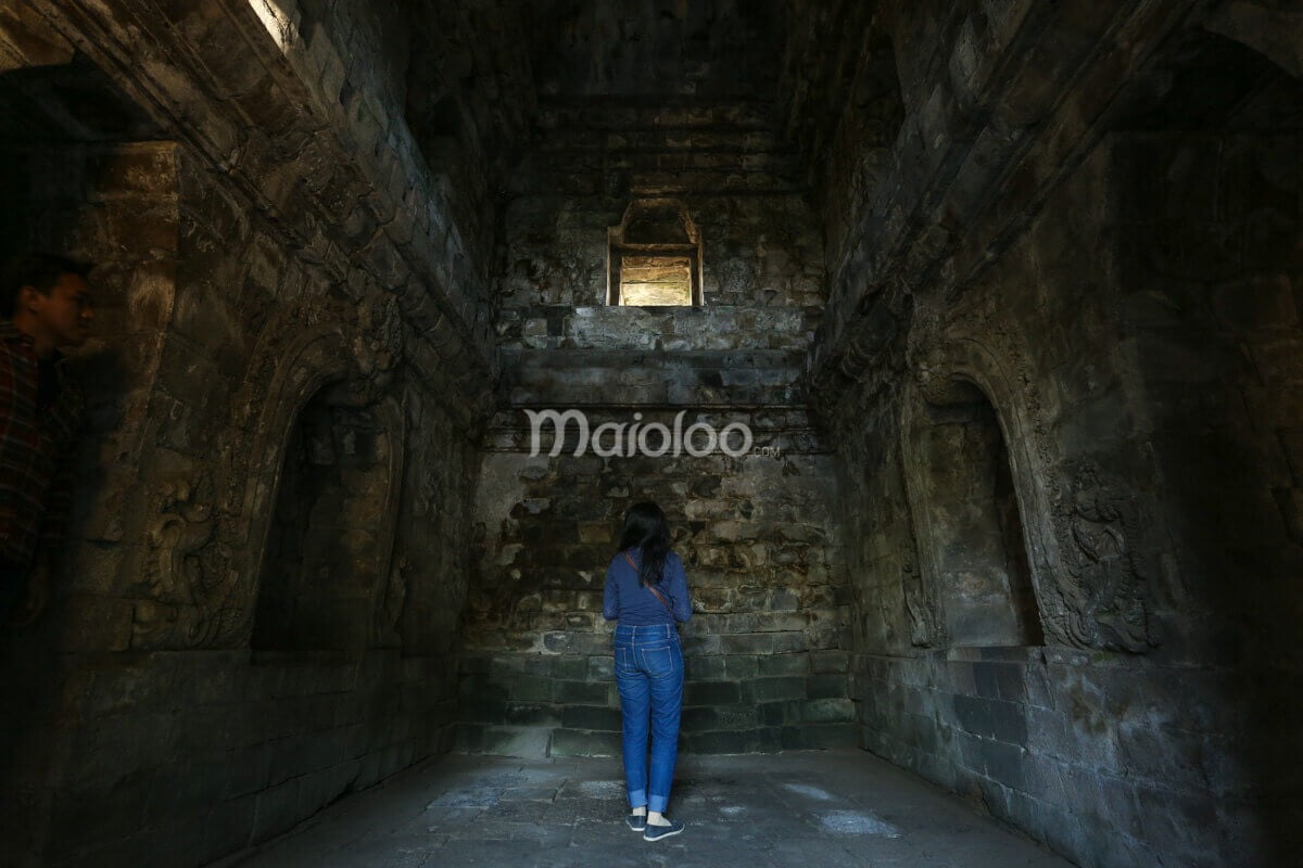 Visitor observing the main chamber inside Sari Temple.