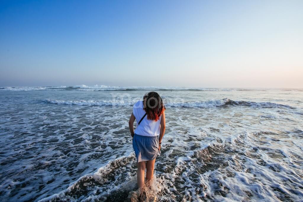A visitor enjoying the waves at Parangtritis Beach.