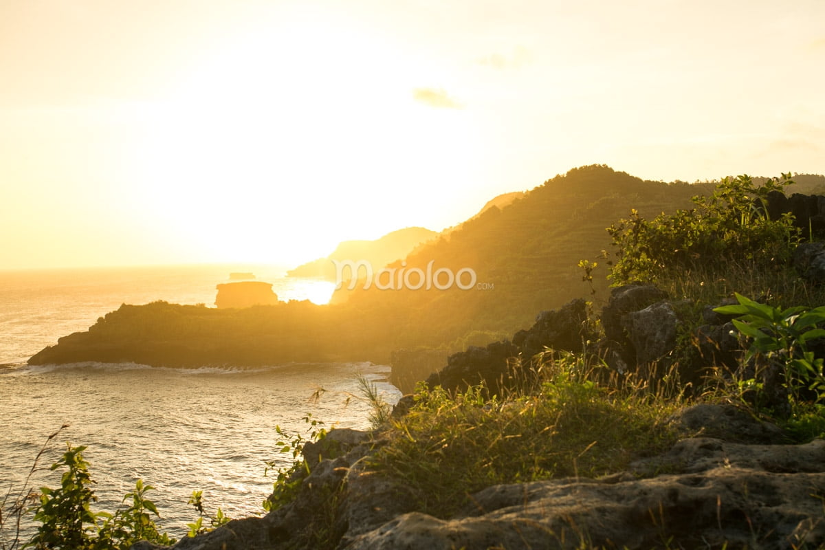 A breathtaking sunset view over the cliffs and ocean at Nglambor Beach.