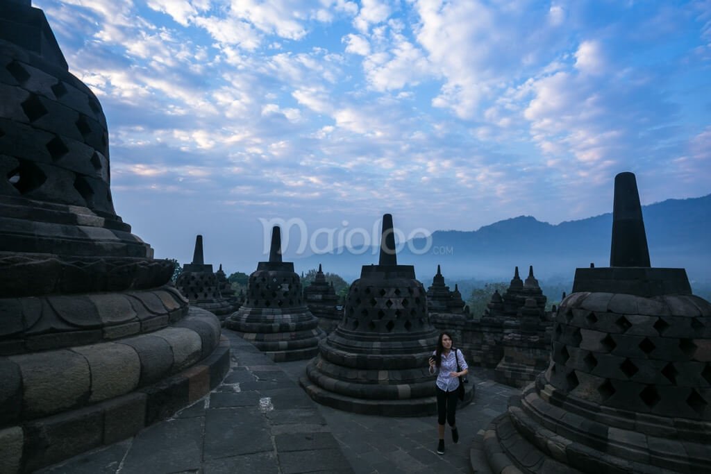Tourists enjoying the sunrise at Borobudur Temple.