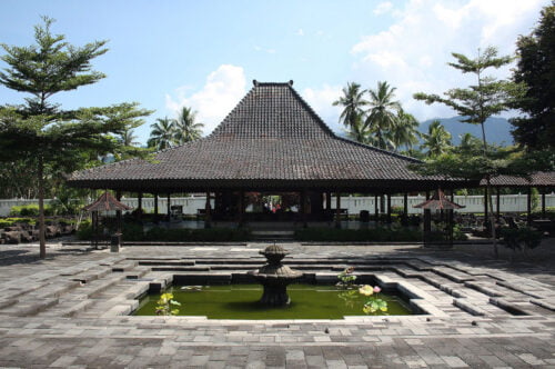 Traditional Javanese building with a fountain pond in front