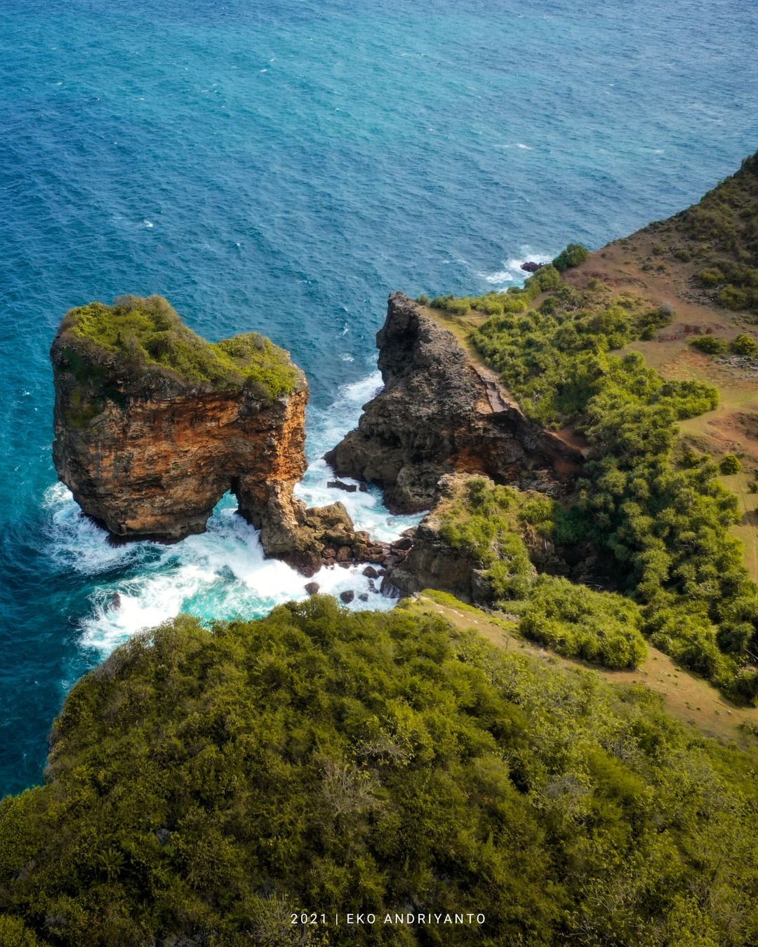 Aerial view of Ngungap Beach showing the cliffs and the blue ocean.