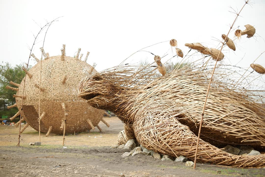 Bamboo sculptures of a turtle and a corona symbol at Trisik Beach.