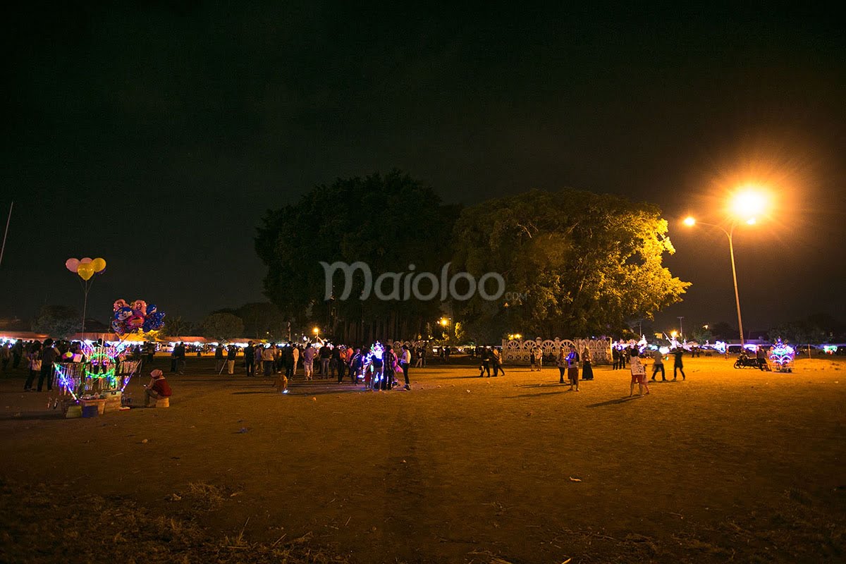 People enjoying the vibrant night at Alun-Alun Kidul in Yogyakarta.