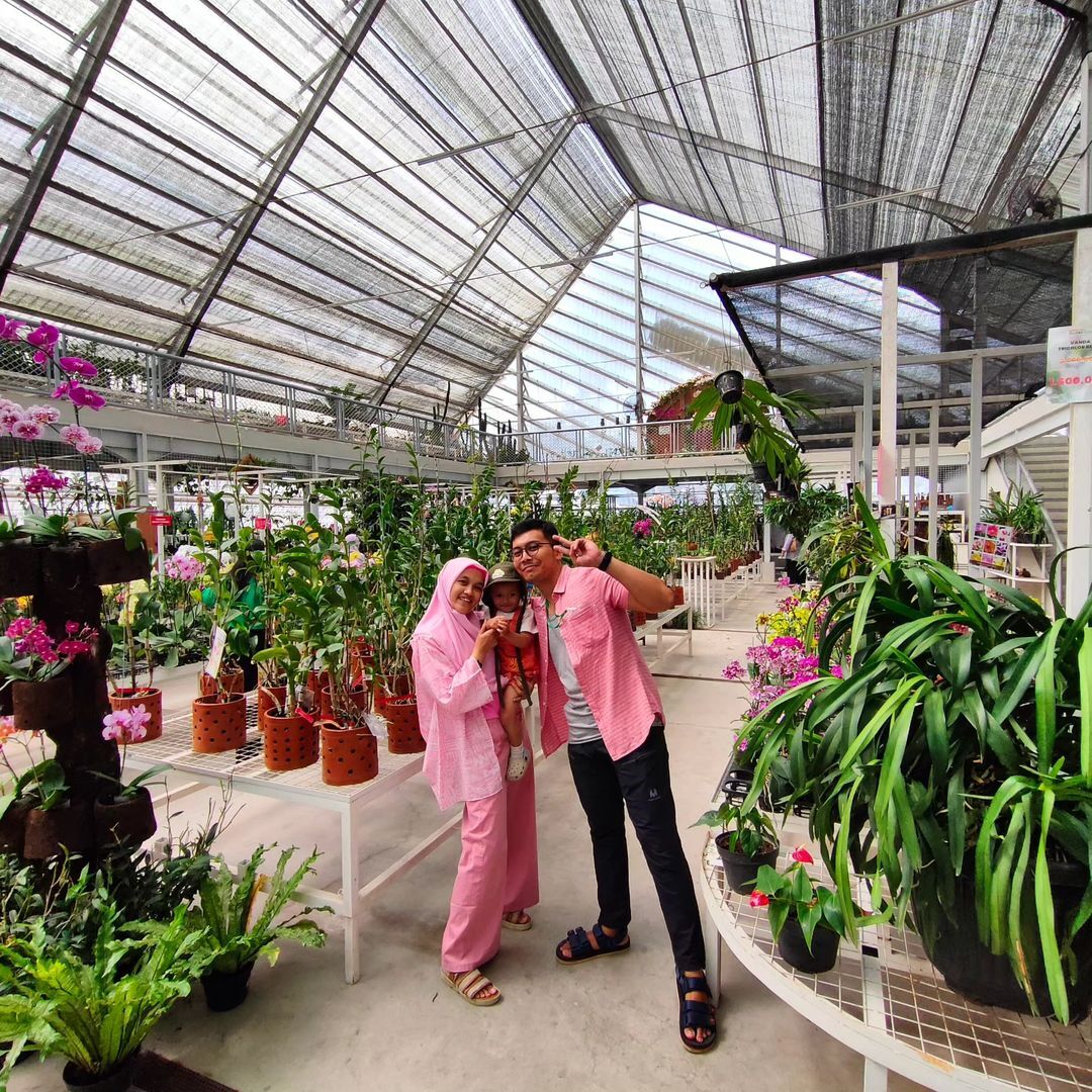 A family posing inside the Green House at Suraloka Interactive Zoo.