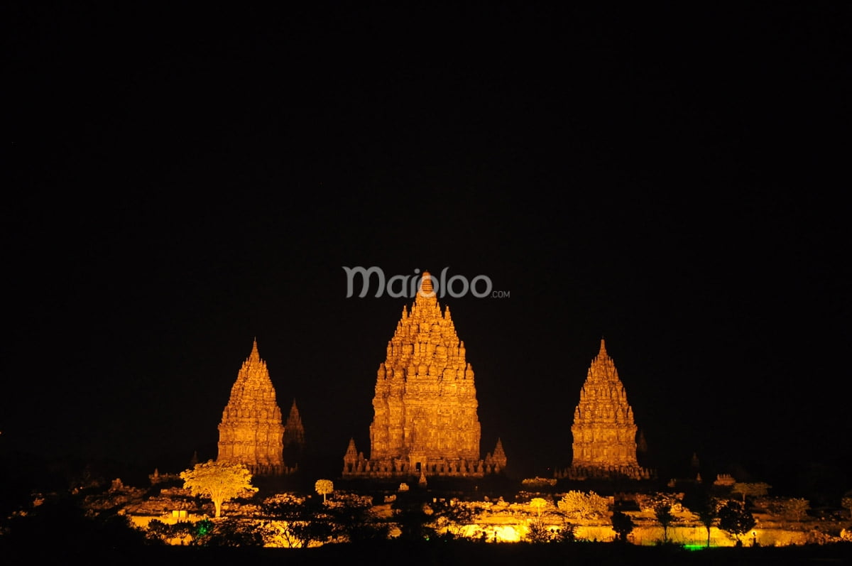 Prambanan Temple illuminated at night.