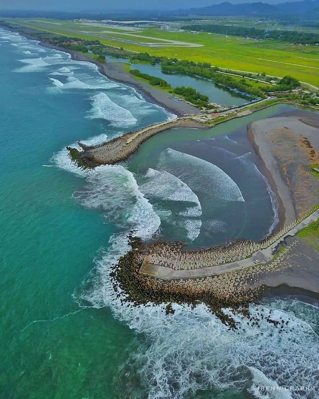 Aerial view of Glagah Beach with visible wave breakers and coastline.