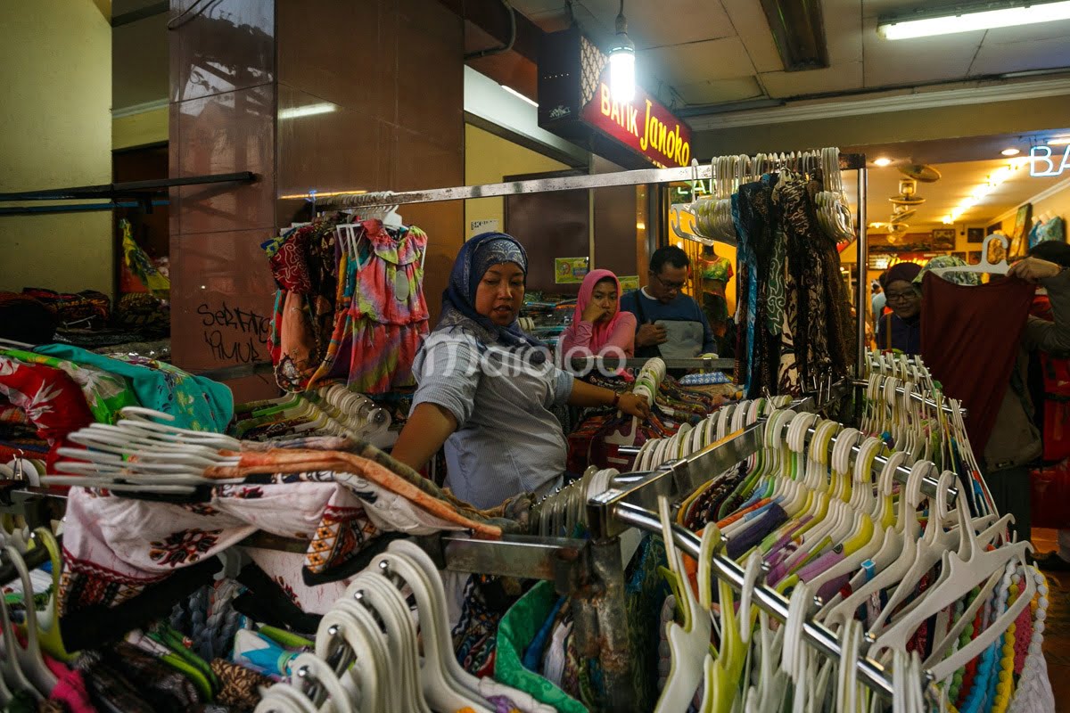 People browse colorful clothes at a street vendor's stall on Malioboro Street.