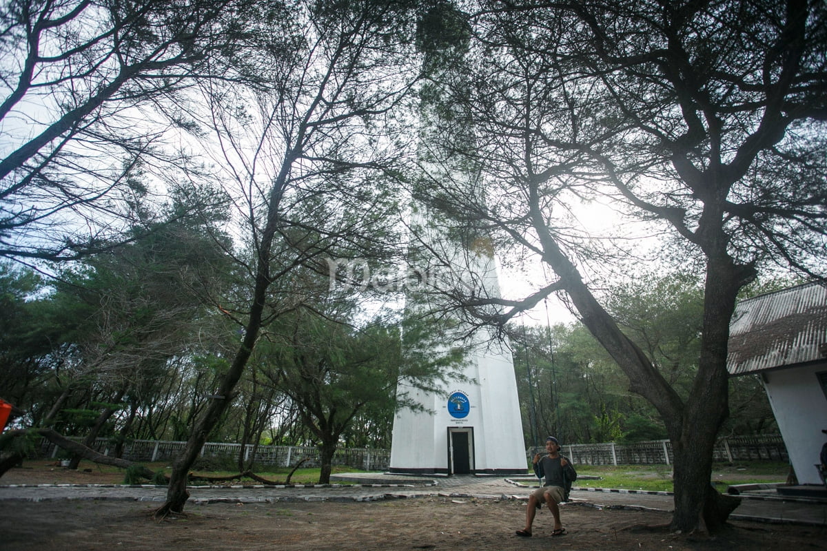 A lighthouse near the trees at Goa Cemara Beach.