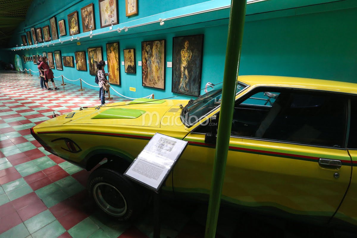 A yellow car and several paintings on display in Affandi Museum's first gallery.