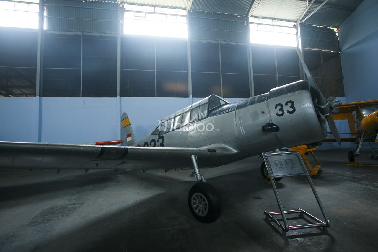 A silver BT-13 Valiant aircraft displayed in the Alutsista room at the Dirgantara Mandala Museum.