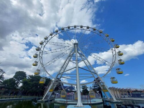 Ferris wheel at Sindu Kusuma Edupark with a blue sky background.