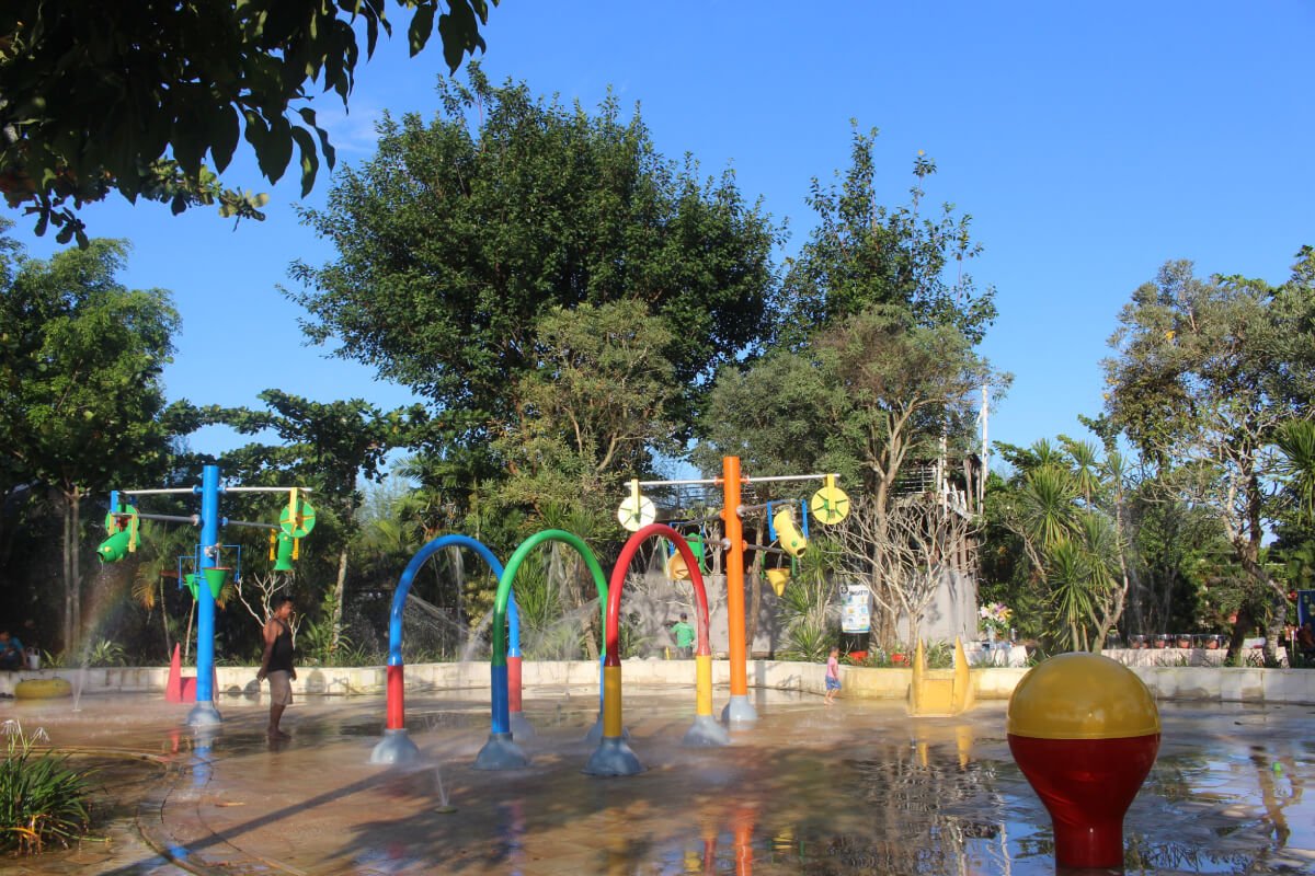 Colorful water play area with arches and sprinklers at Waterboom Jogja.