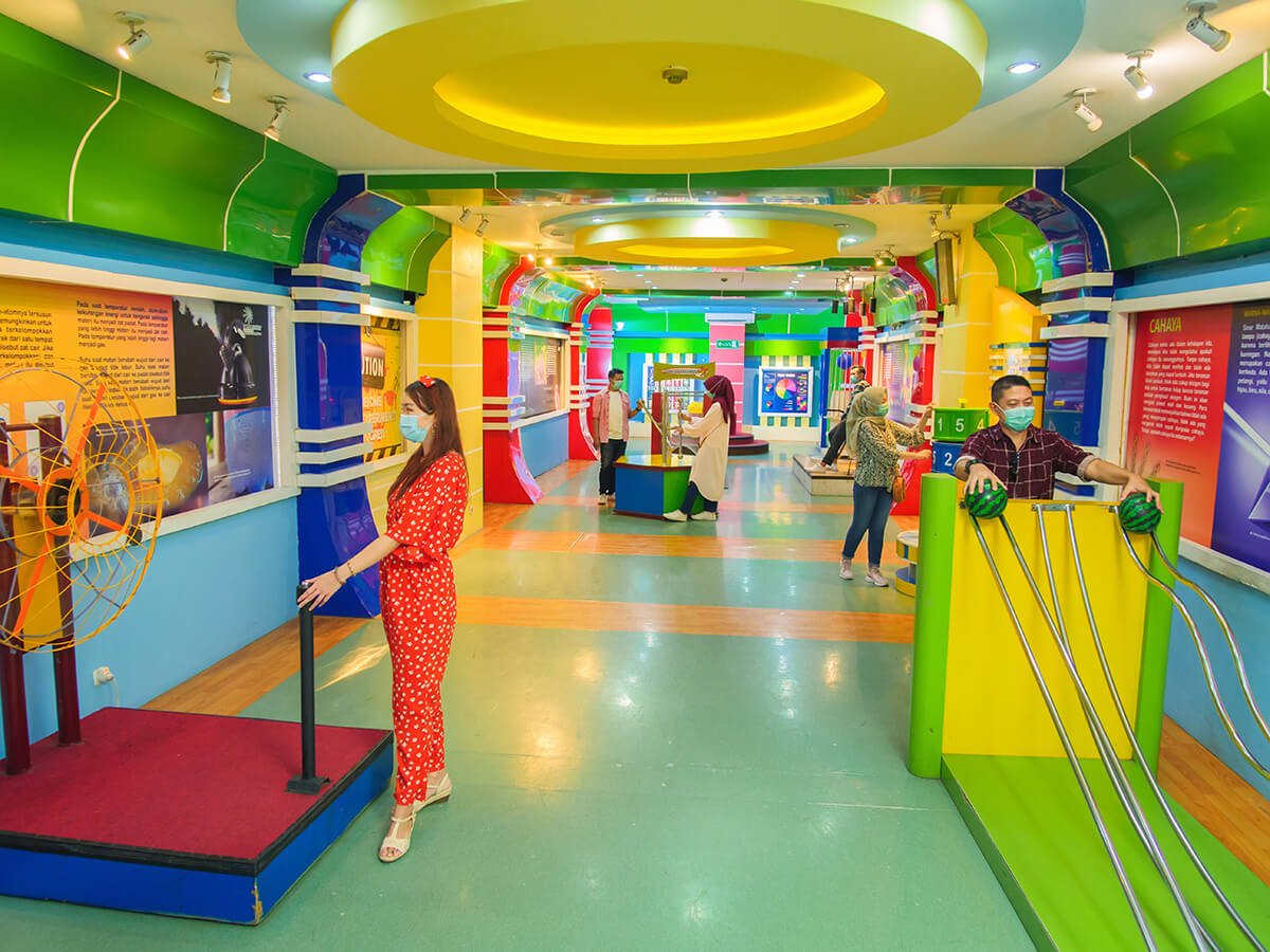 Visitors exploring science exhibits in the Science Bridge Zone at Taman Pintar.