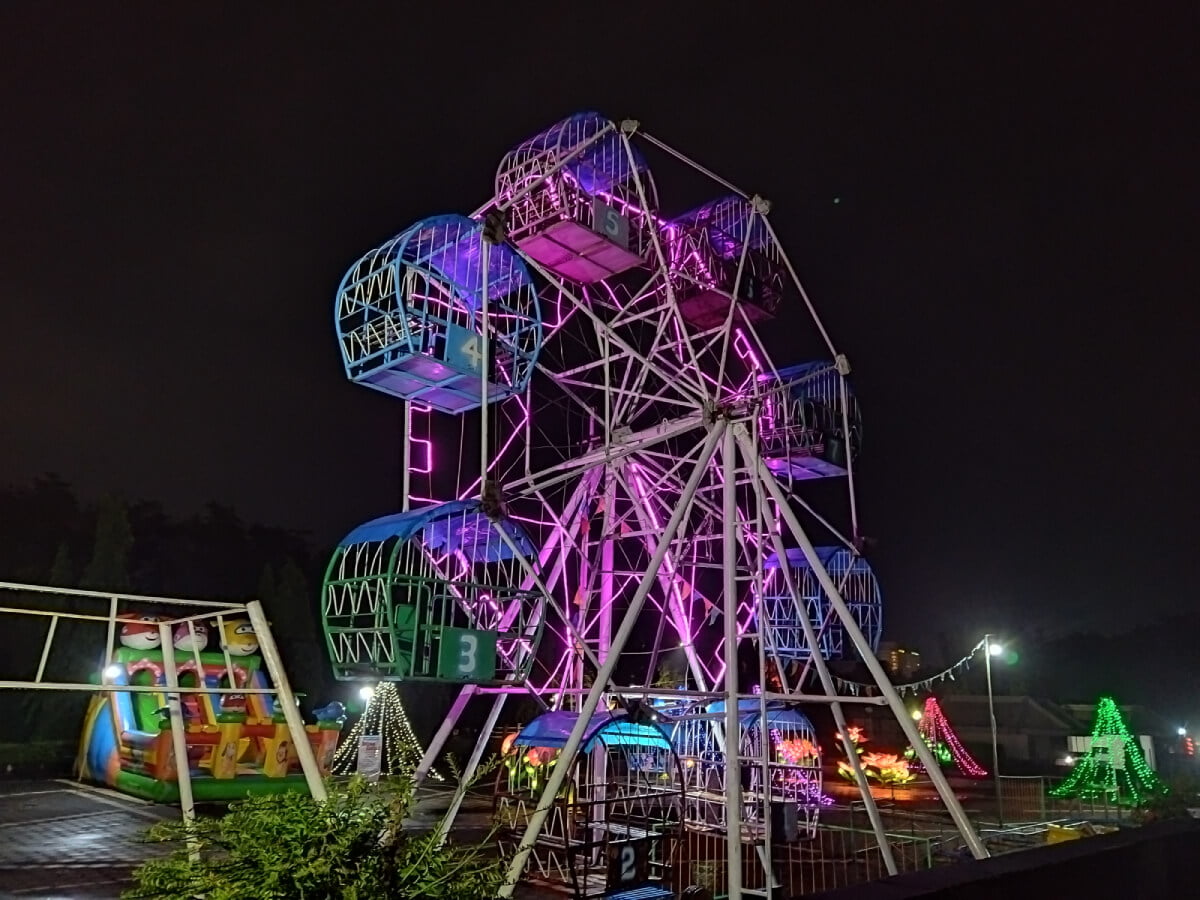 A Ferris wheel lit with colorful lights at Taman Pelangi in Yogyakarta.