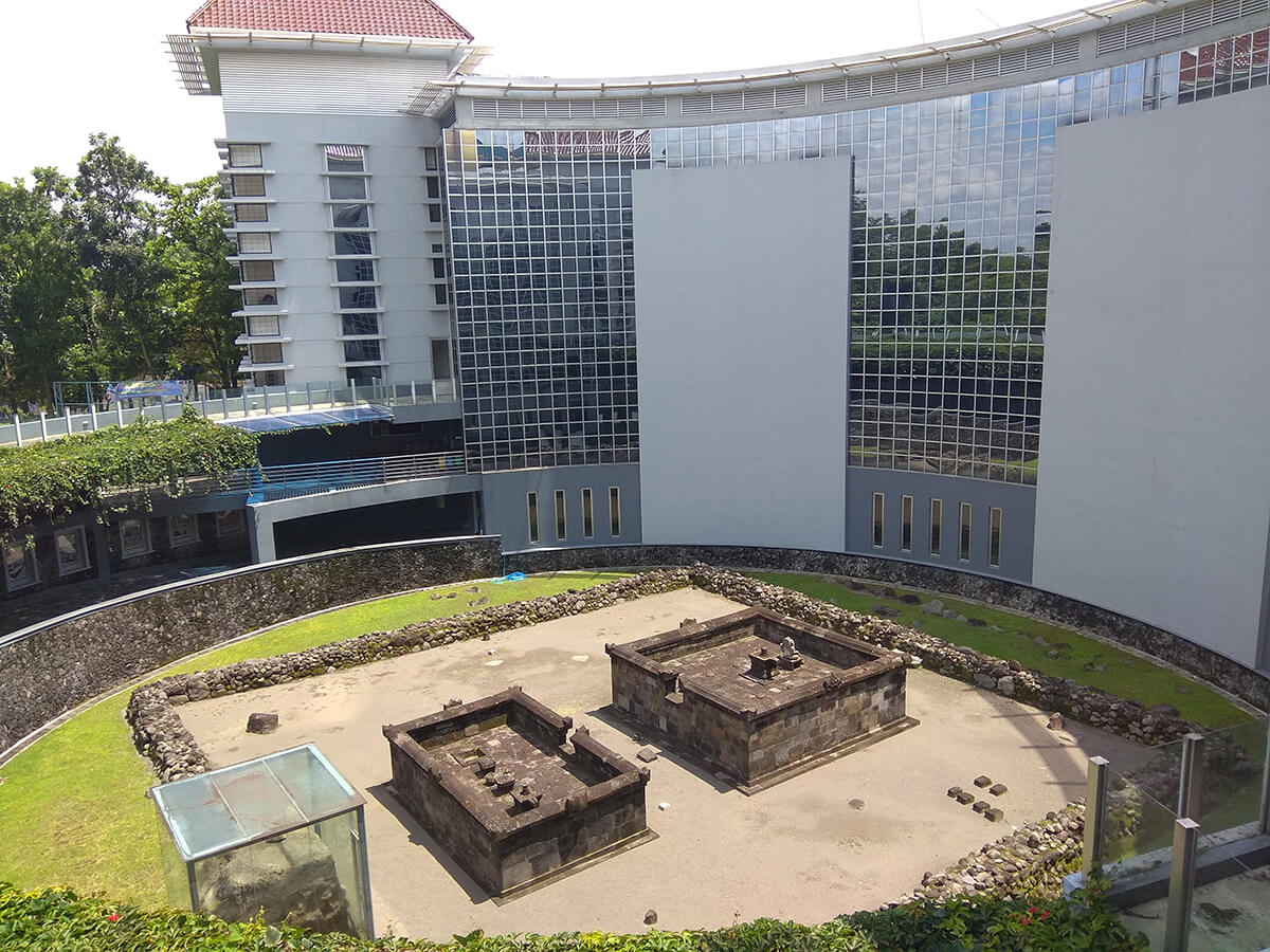 Kimpulan Temple ruins located at the UII campus in Yogyakarta, surrounded by modern university buildings.