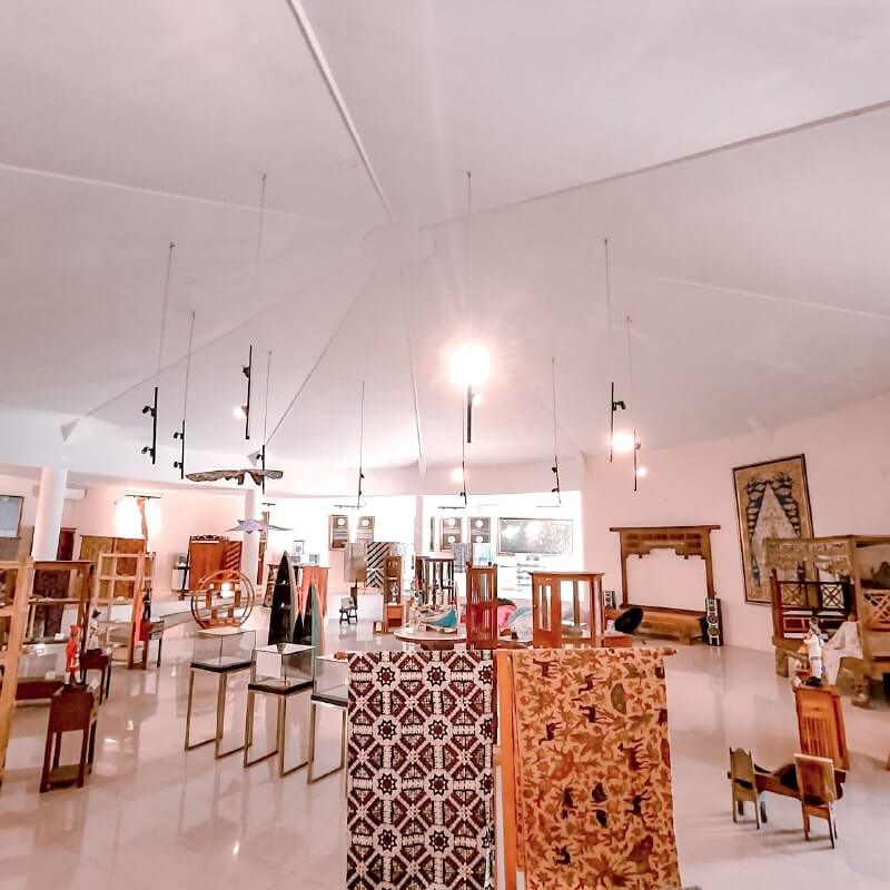 Exhibits of batik and traditional toys in a well-lit room at Sindu Kusuma Edupark.