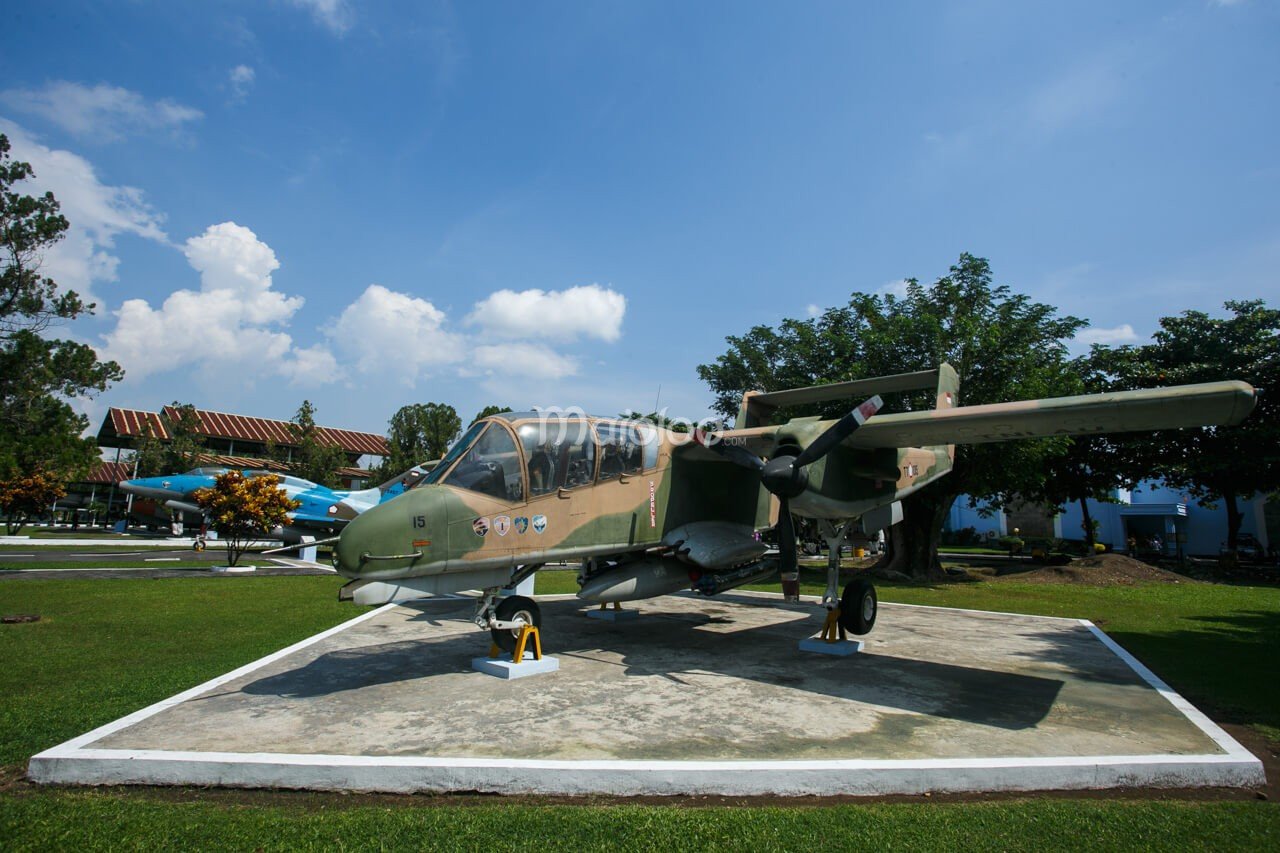 A camouflage-painted aircraft displayed outdoors at the Dirgantara Mandala Museum.