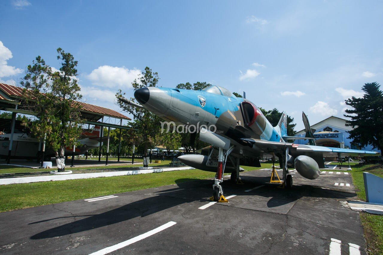 A blue and gray S-4 Skyhawk tactical fighter jet displayed outdoors at the Dirgantara Mandala Museum.