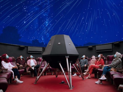 People watching a night sky projection inside the Taman Pintar planetarium.