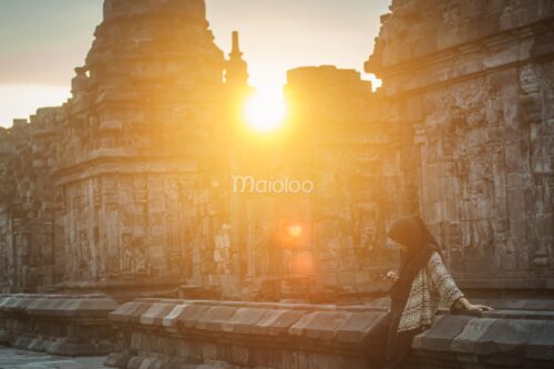 A visitor enjoys the sunset at Sewu Temple in Klaten, Central Java.