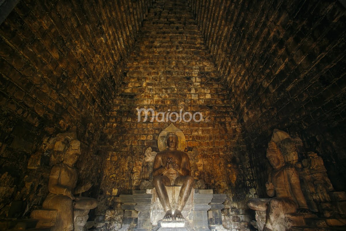 Inside of Mendut Temple with three Buddha statues.