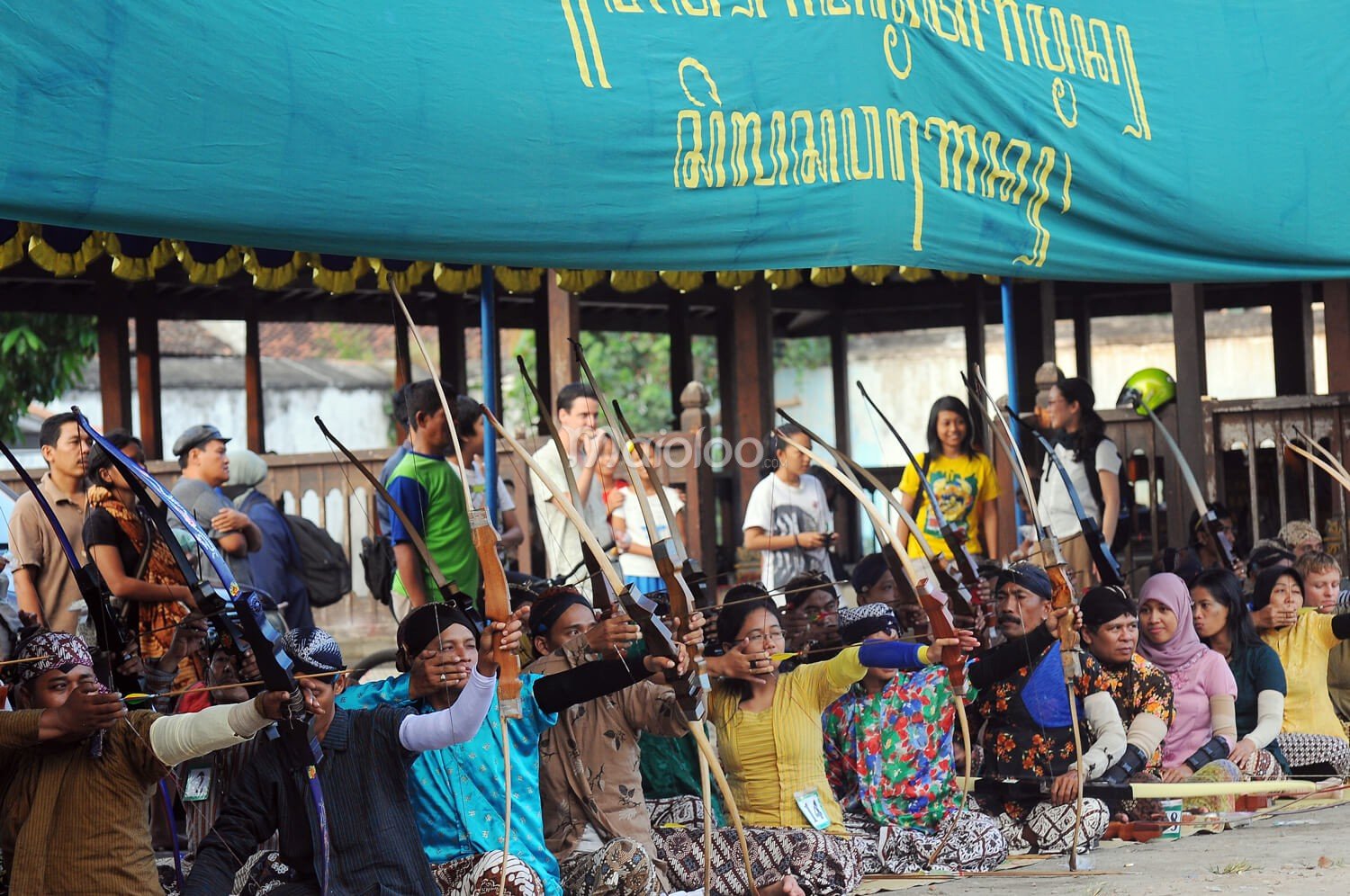 Participants taking aim in a traditional Jemparingan archery competition.