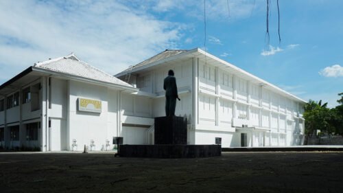 The exterior of Jogja National Museum with a statue in front.