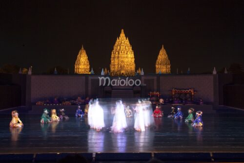 Dancers performing at the Ramayana Ballet in front of Prambanan Temple at night.