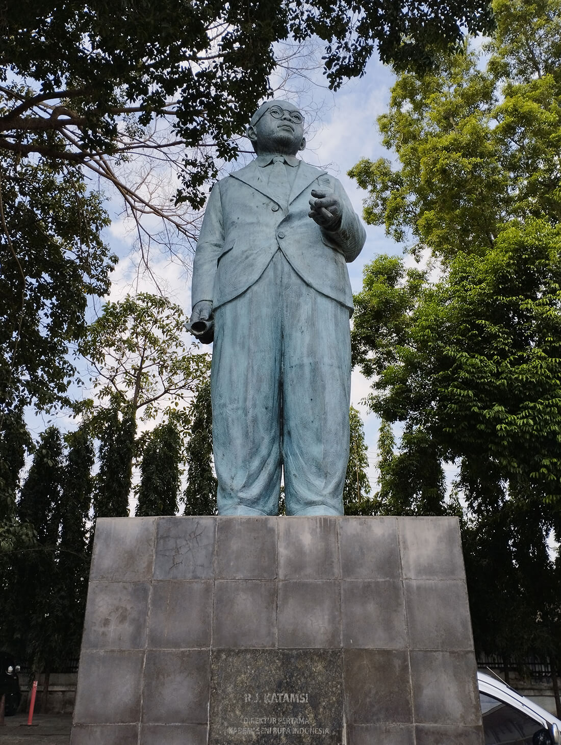 A tall statue of a man in a suit at Jogja National Museum.