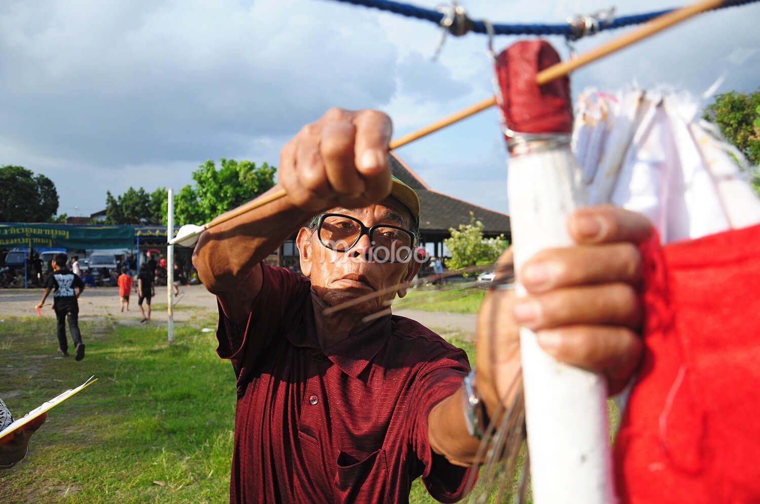 An official retrieving an arrow from the target at the Jemparingan event.