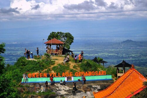 People enjoying the view from a gazebo on a hilltop at Green Village Gedangsari in Gunungkidul, Yogyakarta.