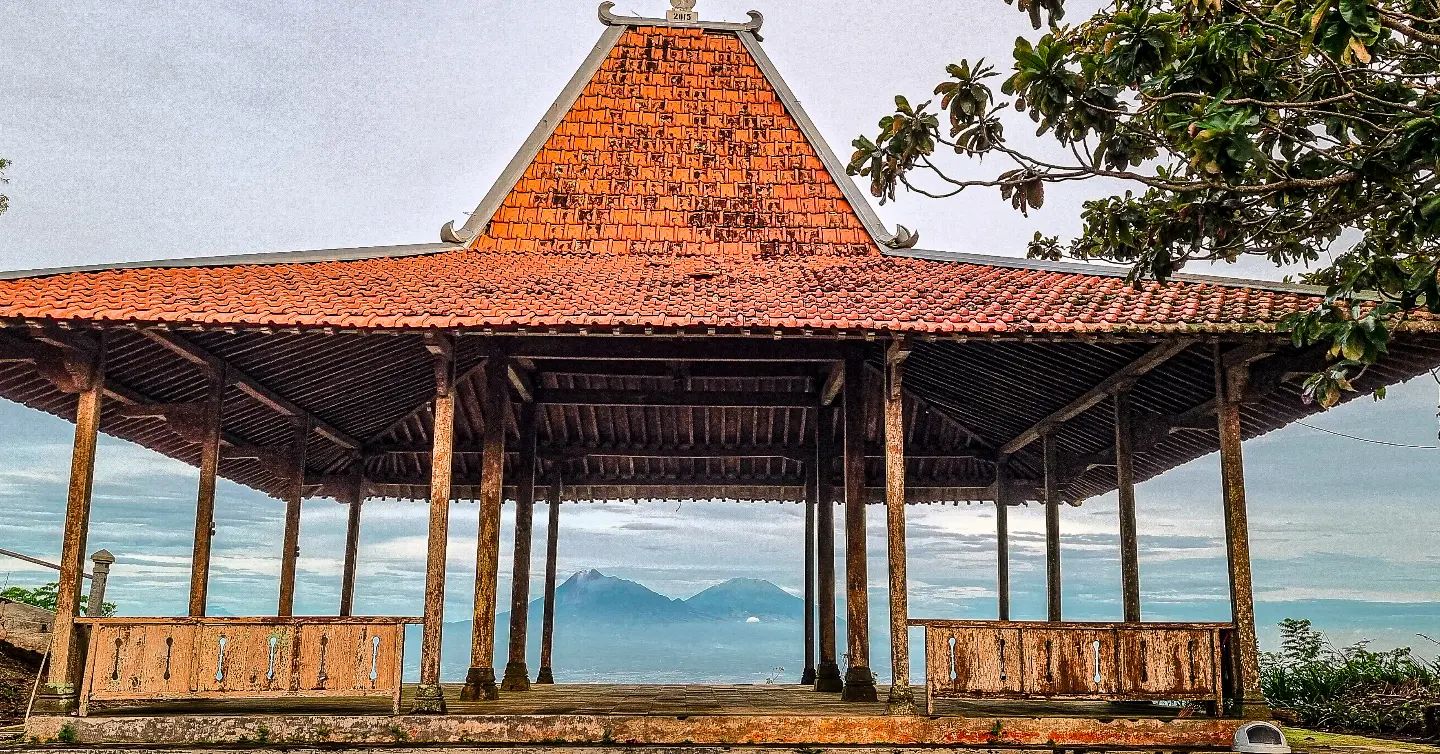 Traditional pavilion at Gunung Gambar with a view of Mount Merapi and Mount Merbabu in the distance.