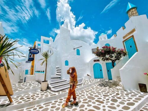 White buildings with blue doors and windows resembling Santorini at Bhumi Merapi Agrotourism.