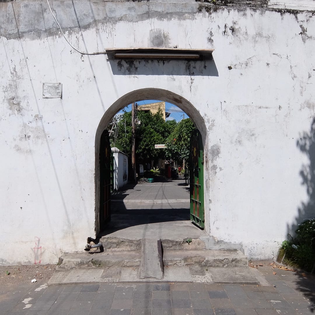 An arched entrance leading to an alleyway in Kauman Village.