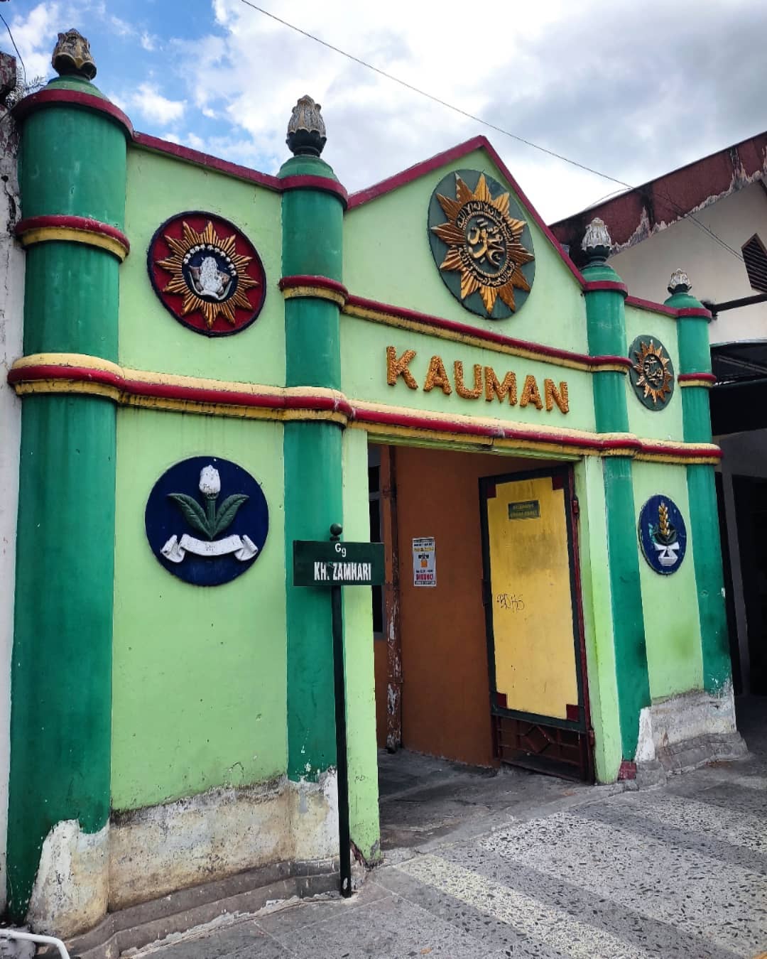 The colorful entrance gate to Kauman Village with decorative symbols.