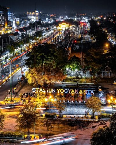 Night view of Yogyakarta Station in Yogyakarta, with bright lights and bustling activity.